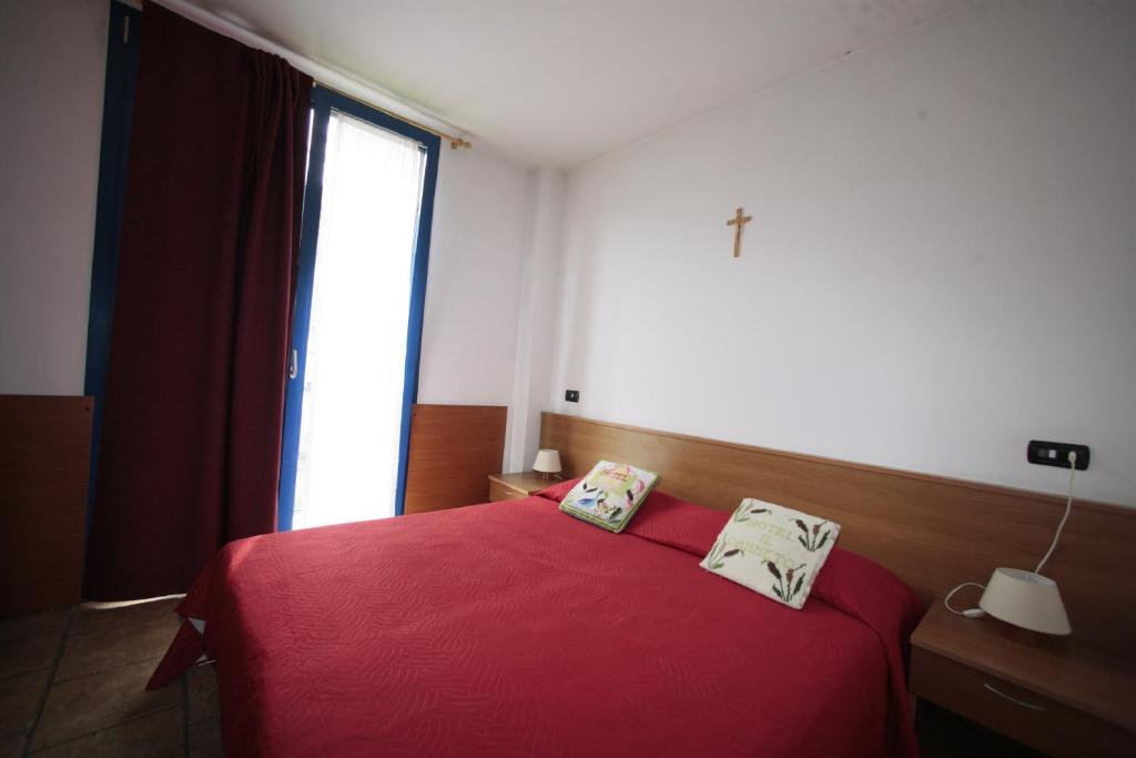Postel nebo postele na pokoji v ubytování Hotel Il Canneto