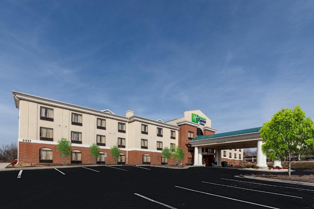 a hotel with a parking lot in front of it at Holiday Inn Express Hotel & Suites Greensboro-East by IHG in Greensboro