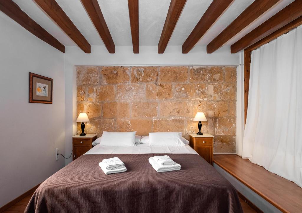 a bedroom with a bed with two towels on it at Ramón Llull House in Palma de Mallorca