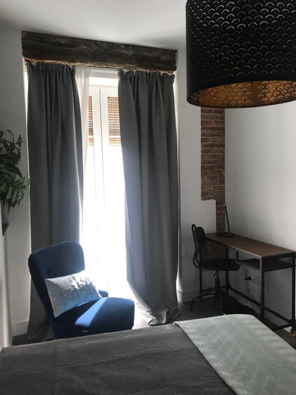 A bed or beds in a room at Apartamentos DUKE