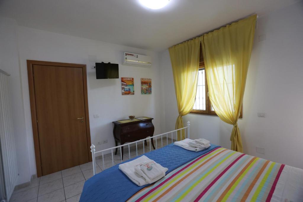 A bed or beds in a room at La Casa del Gelso Fiorito