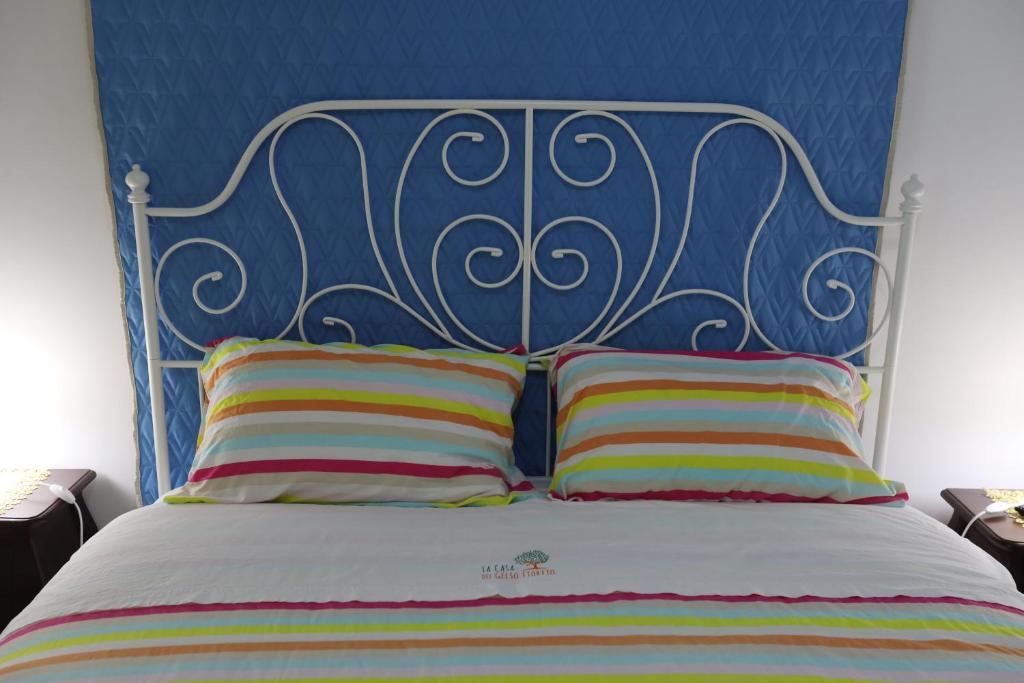 A bed or beds in a room at La Casa del Gelso Fiorito