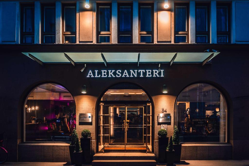 a store front with the entrance to an allezmarkett building at Radisson Blu Aleksanteri Hotel, Helsinki in Helsinki