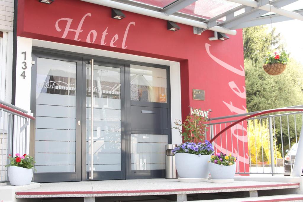 a front door of a store with potted plants at Hotel Bürger in Siegen
