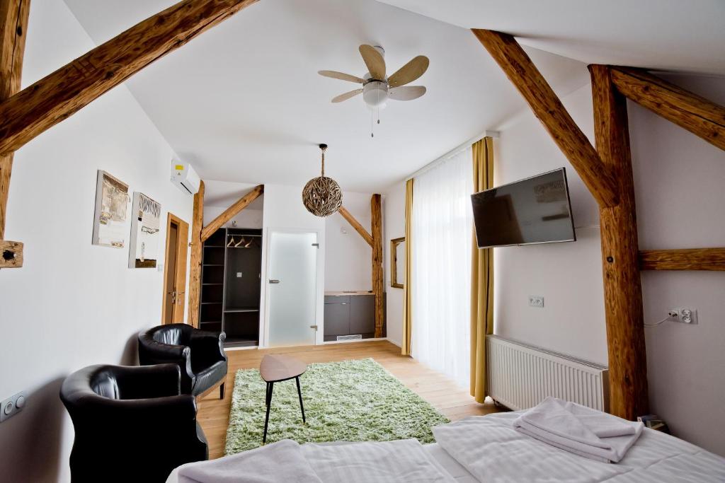 a bedroom with a bed and a tv on the wall at Salon Win Wine Bar & Apartments in Jasło