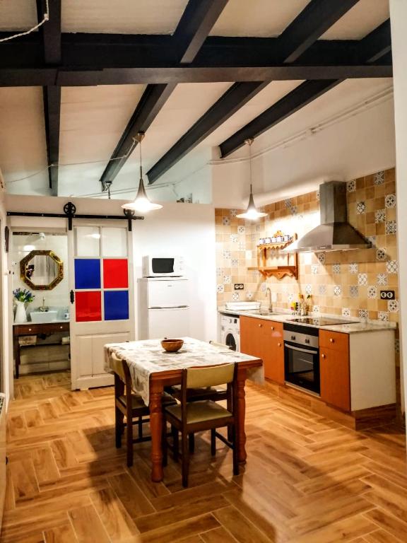 a kitchen with a wooden table in a room at ATICO Loli in Berga
