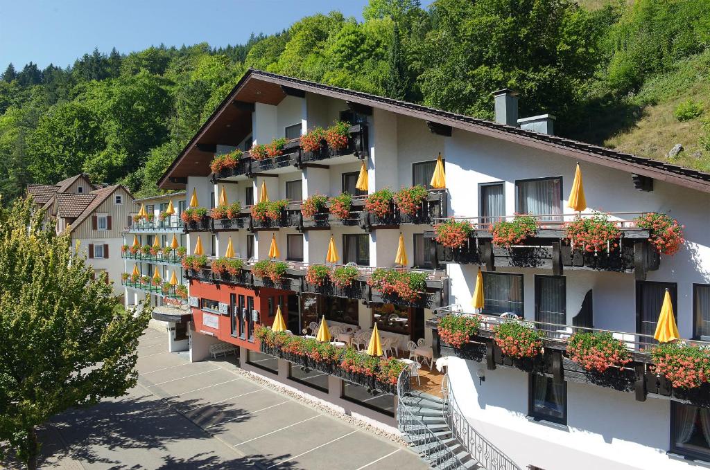 a building with flowers on the balconies of it at Flair Hotel Sonnenhof in Baiersbronn