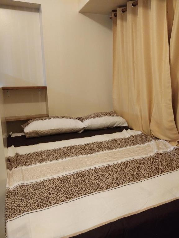 Postel nebo postele na pokoji v ubytování Avida Atria Khalexa's Place Iloilo
