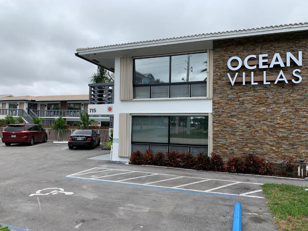 a ocean villas sign on the side of a building at Ocean Villas of Deerfield in Deerfield Beach