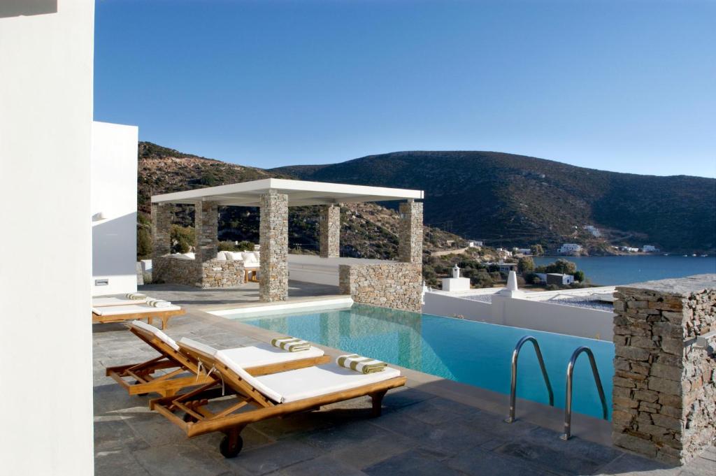 a villa with a pool and a view of the ocean at Elies Resorts in Vathi