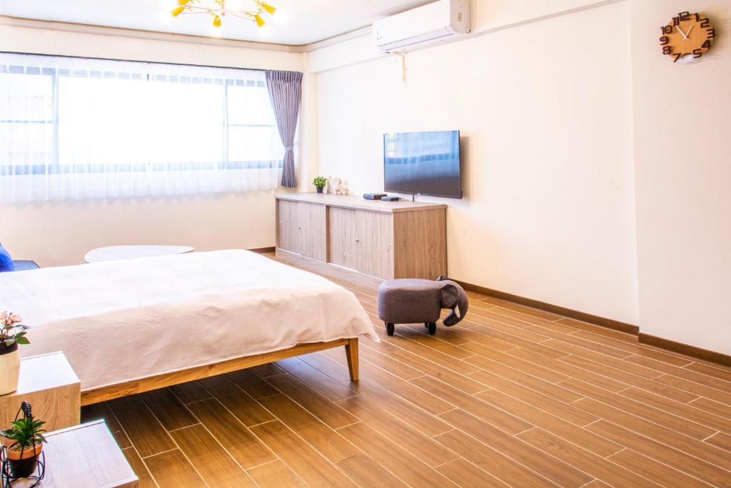 a bedroom with a bed and a tv in it at ioio in Tainan