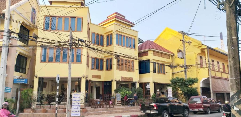 a group of buildings on a city street at Ban Mae Boonthong in Lampang