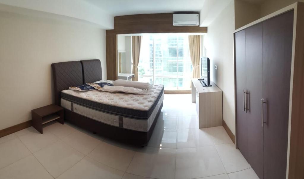 Giường trong phòng chung tại Mataram City Apartment 700 Sadewa
