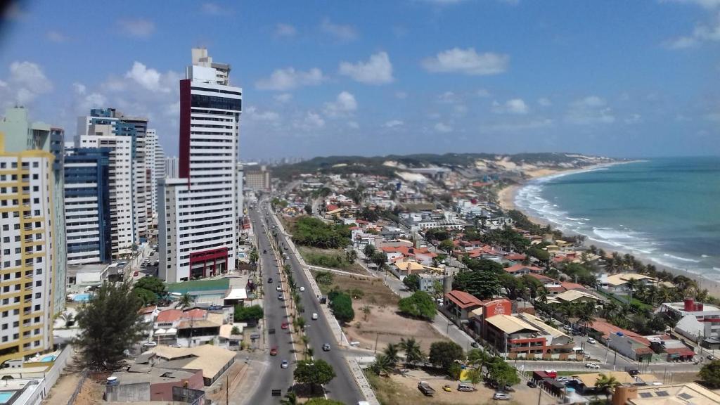 an aerial view of a city and the ocean at Apartamento Duna Barcane 1801 in Natal