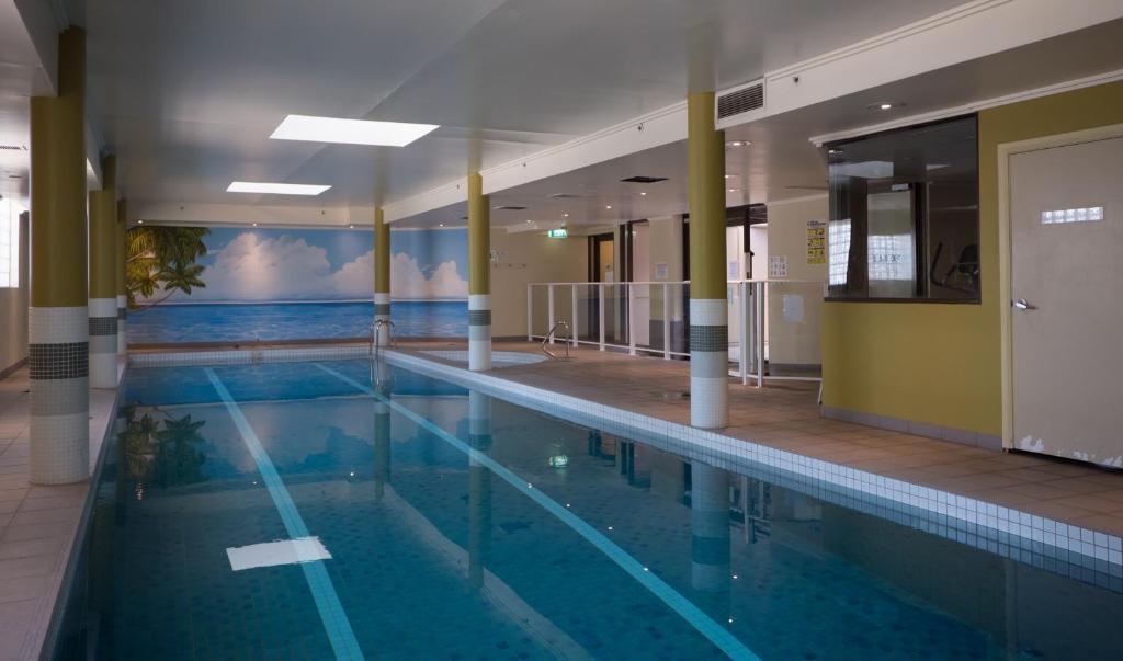 a large swimming pool with a mural of the ocean at Fiori Apartments in Sydney