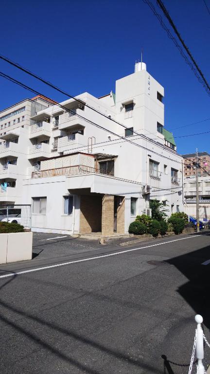 a white building on the side of a street at Cherry Blossom Koseicho in Okayama