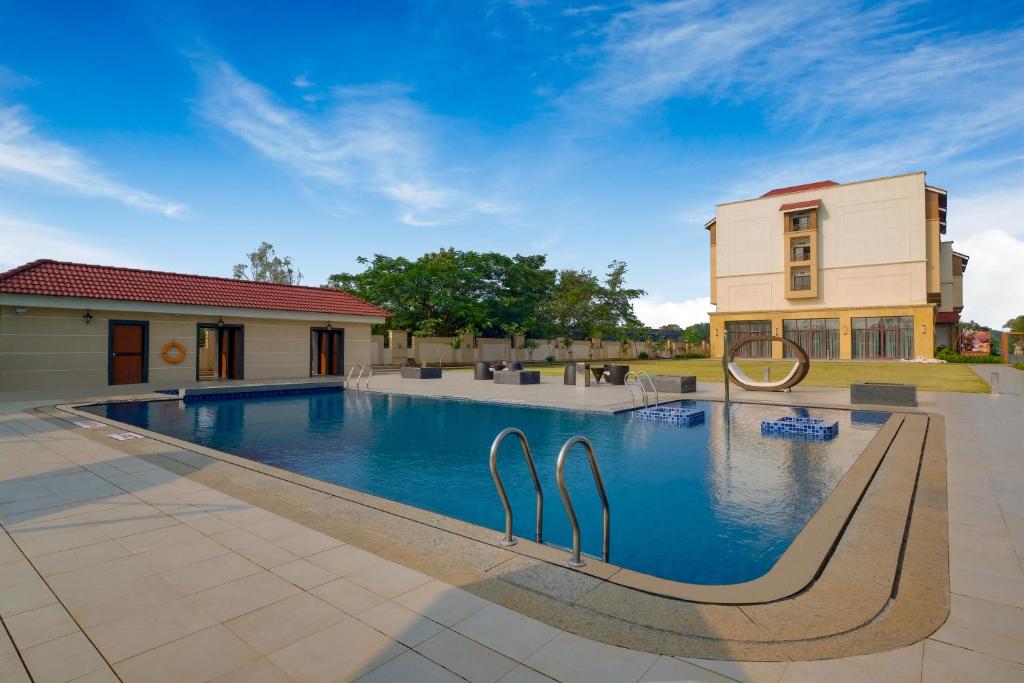 una piscina frente a una casa en The Fern An Ecotel Hotel, Lonavala, en Lonavala
