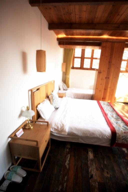 Postel nebo postele na pokoji v ubytování Begonia Flowers Guesthouse