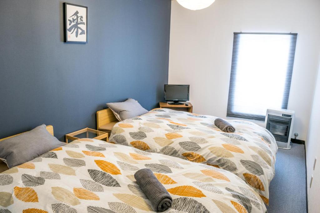 Postel nebo postele na pokoji v ubytování Myoko House