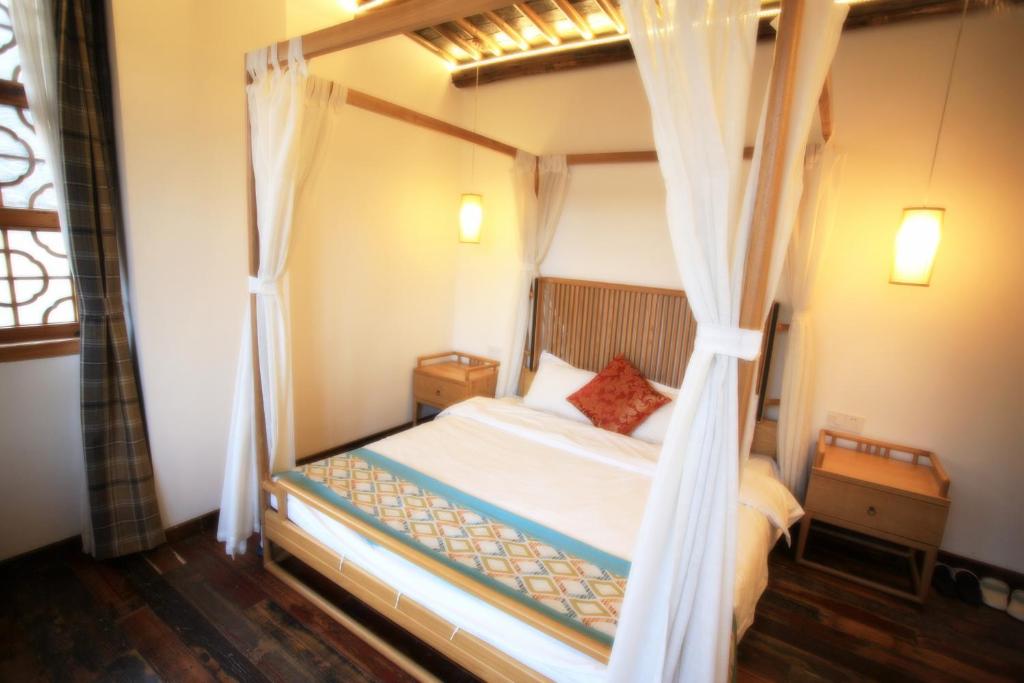 Postel nebo postele na pokoji v ubytování Begonia Flowers Guesthouse