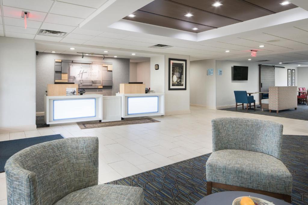 a waiting room with two chairs and a counter at Holiday Inn Express Louisville Northeast by IHG in Louisville