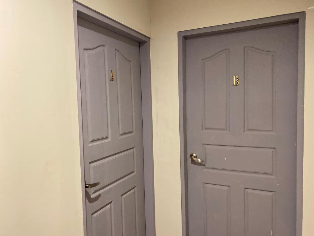 two doors next to each other in a room at Saint Hostel in Beigang