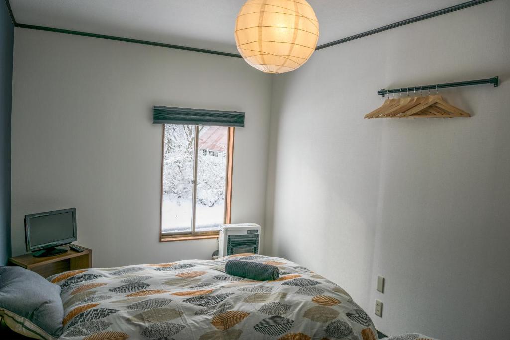 Postel nebo postele na pokoji v ubytování Myoko House