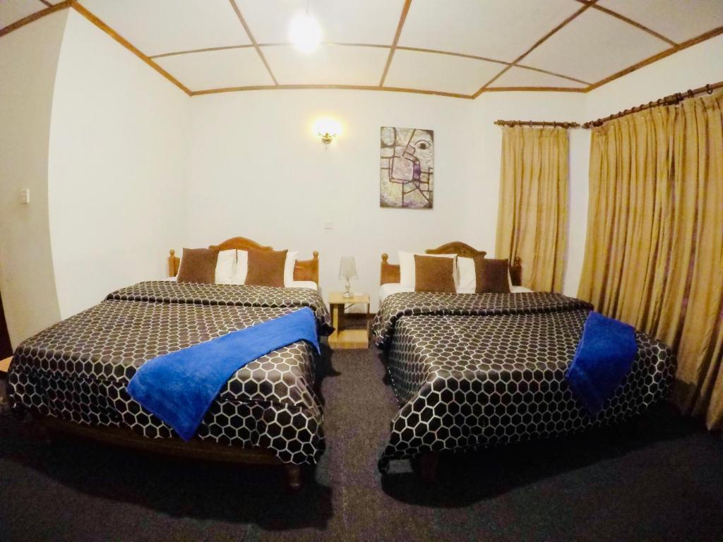Postel nebo postele na pokoji v ubytování New Royal Mount Hotel