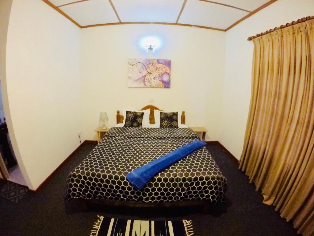 Postel nebo postele na pokoji v ubytování New Royal Mount Hotel