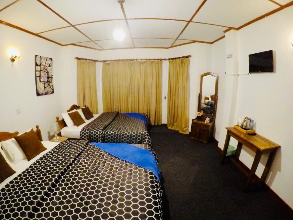 Postel nebo postele na pokoji v ubytování New Royal Mount Hotel