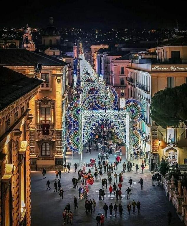 a group of people walking around a street with a christmas tree at Brand New Central Apartments in Sarajevo