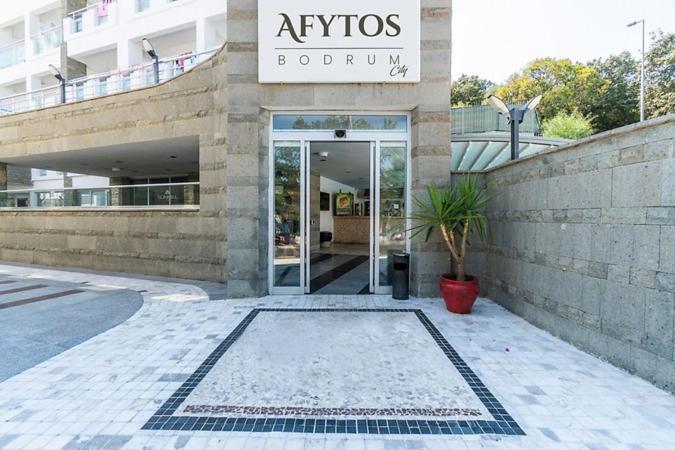 a building with a potted plant in front of it at Afytos Bodrum City in Mugla