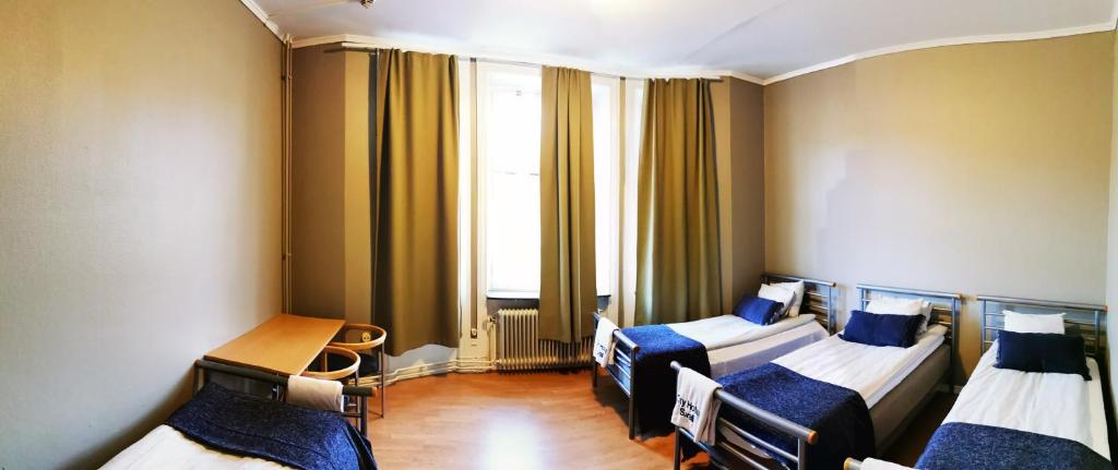 Postel nebo postele na pokoji v ubytování Sundsvall City Hotel