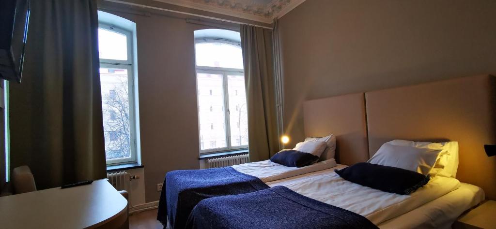 Postel nebo postele na pokoji v ubytování Sundsvall City Hotel