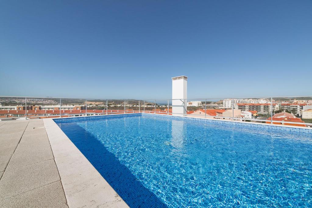 a large swimming pool on top of a building at Sunset - Holiday Apartment - By SCH in São Martinho do Porto