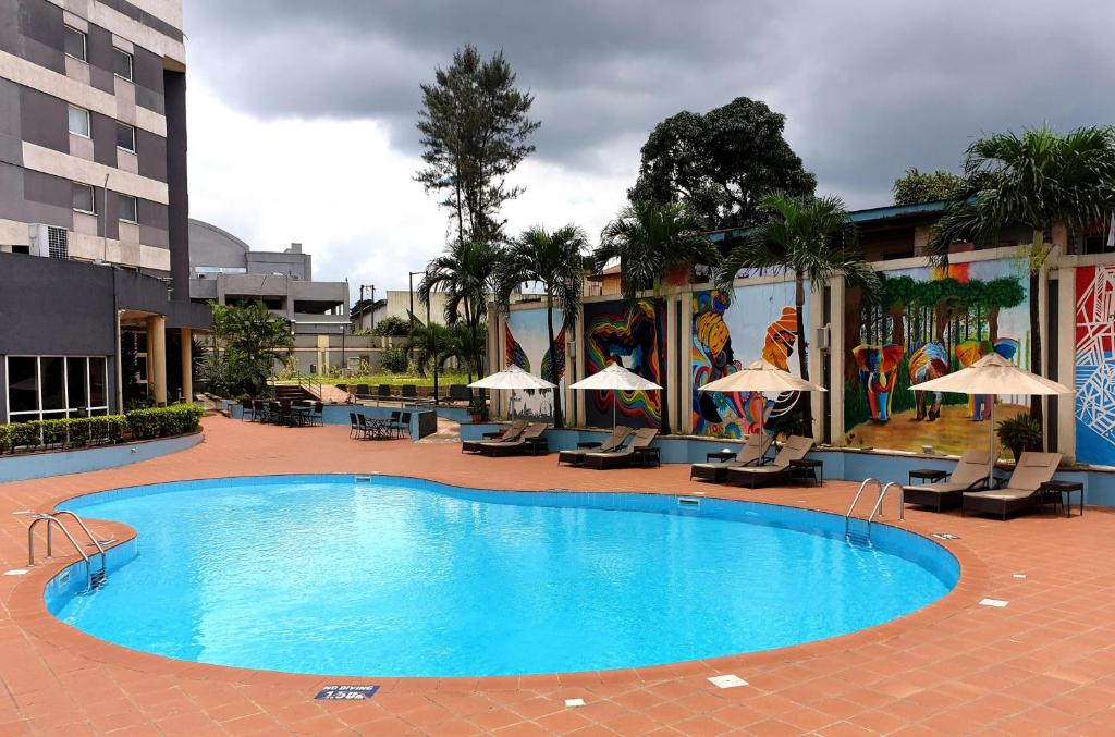 a large swimming pool in front of a building at Novotel Port Harcourt in Port Harcourt