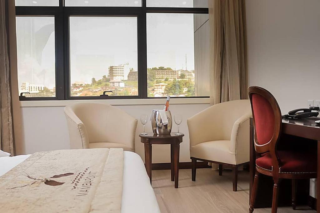 Postel nebo postele na pokoji v ubytování Mamba Point Hotel