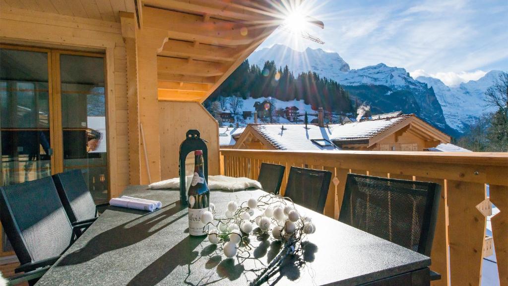 a snowboard sitting on top of a table on a balcony at Panoramapark Soleil Chalet E in Wengen