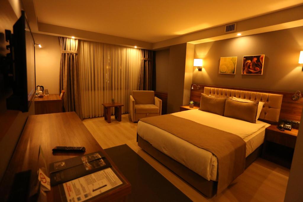 Postel nebo postele na pokoji v ubytování Oytun Park Hotel