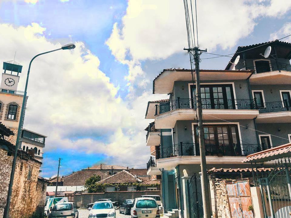 a building with cars parked in front of it at ODA Guest House in Korçë