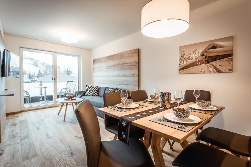 a dining room with a table and a couch at Apartments Gustav by Schladming-Appartements in Schladming