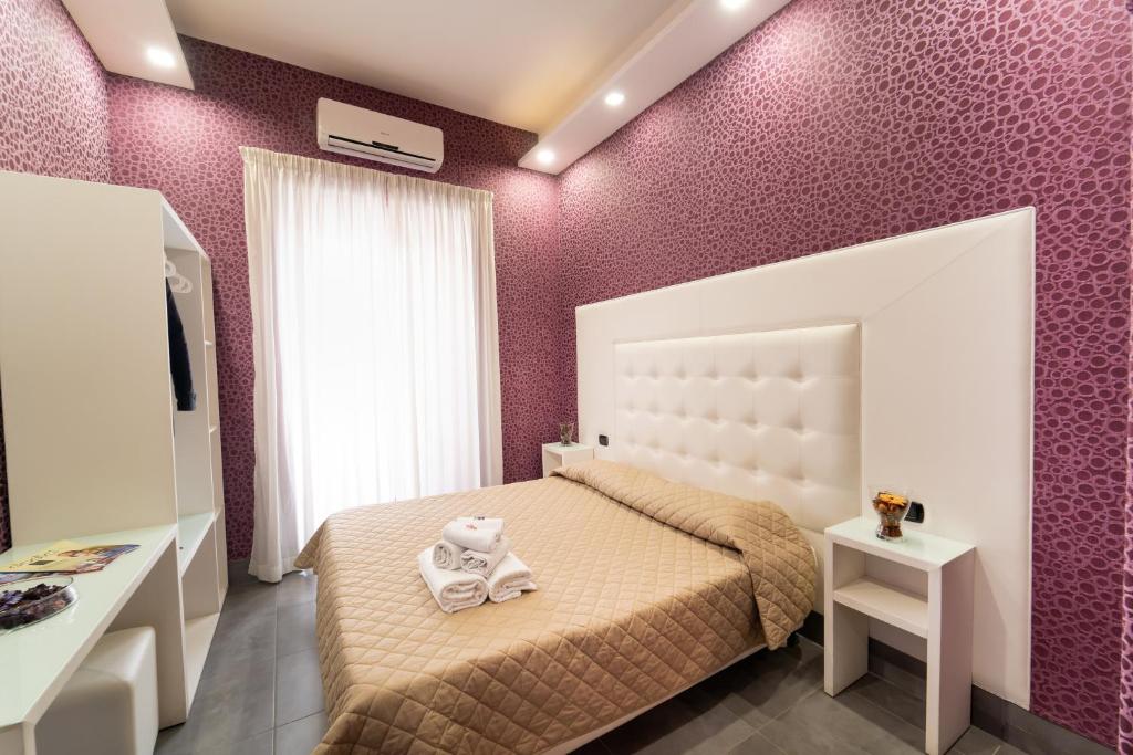 a bedroom with a bed with a teddy bear on it at Royal House Napoli Centro, by ClaPa Group in Naples