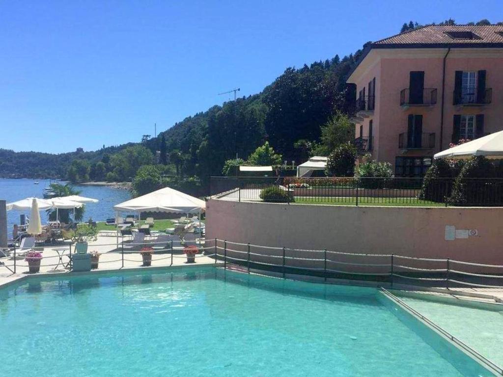 a large pool of water in front of a building at Brand new and elegant residence on Lake Maggiore in Meina