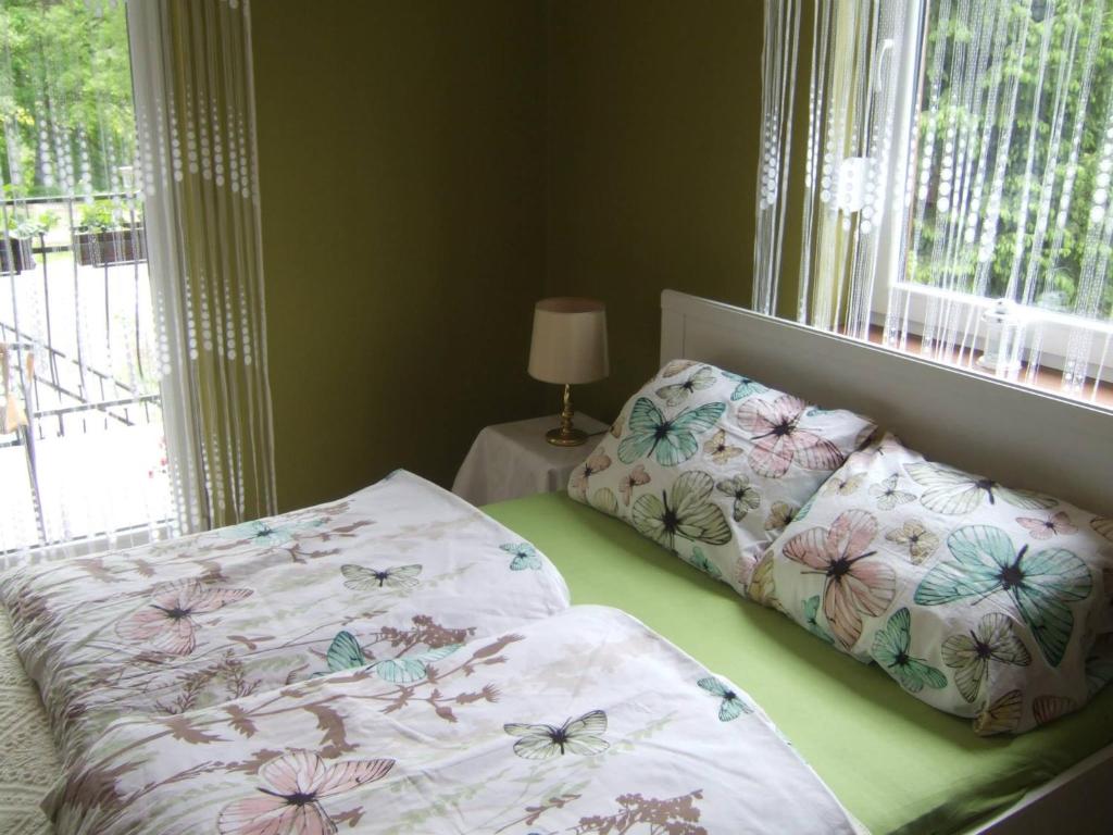 1 dormitorio con cama y ventana con mariposas en Dom nad Bobrem Agatowe Kamyki, en Wleń