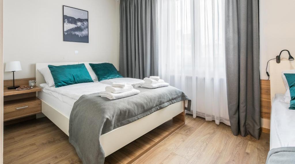 sypialnia z łóżkiem z ręcznikami w obiekcie Willa Goszczyńskiego w Zakopanem