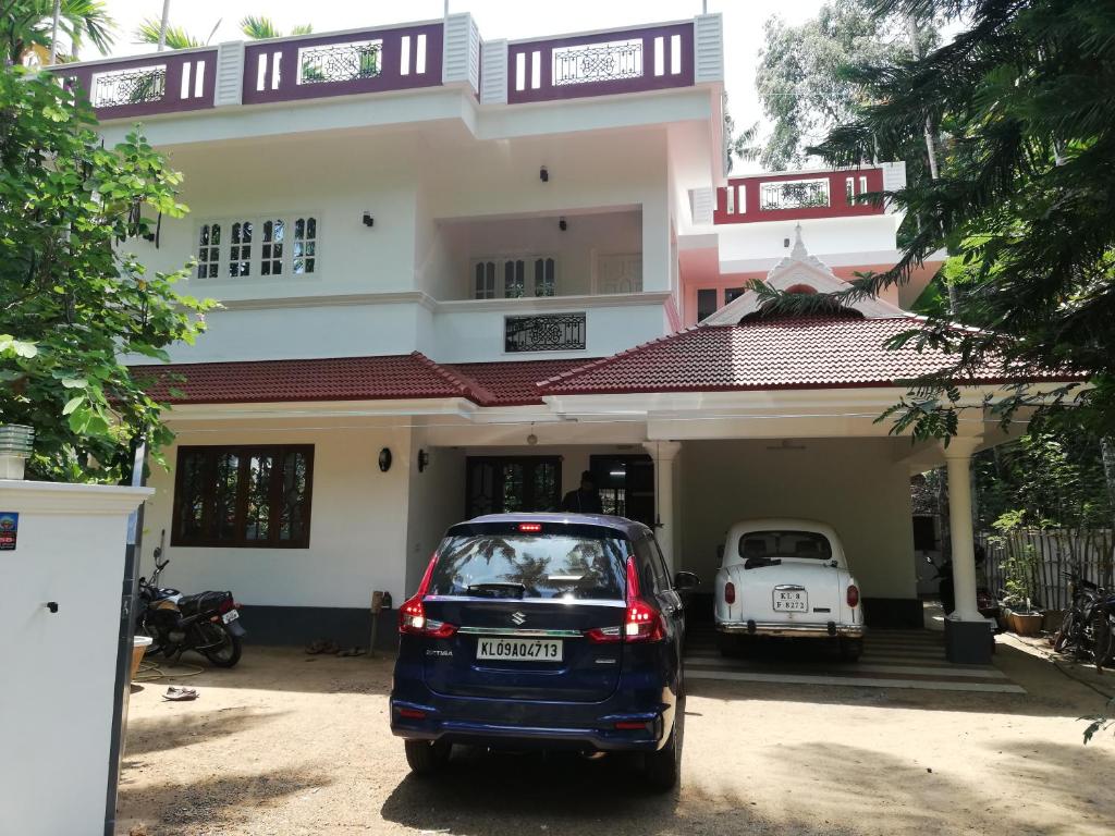 a car parked in front of a house at Takashi Homestay North Paravur Near Muziris in North Paravur