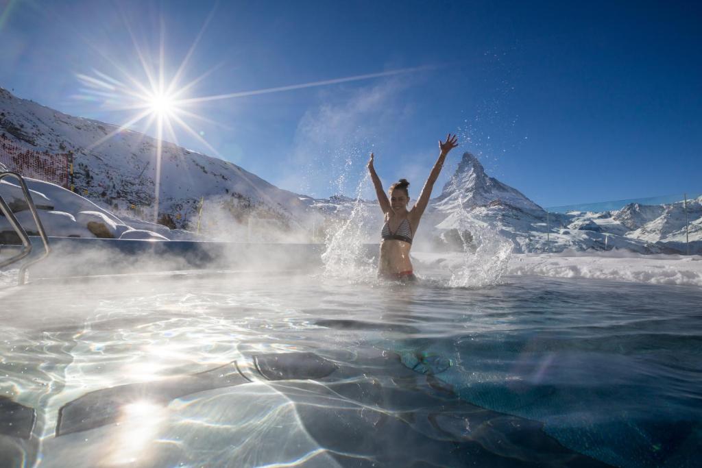 a person in the water with a snowboard at Riffelalp Resort 2222m - Ski-in, Ski-out in Zermatt