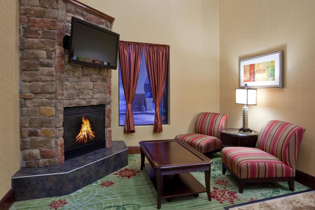 a living room filled with furniture and a fire place at Holiday Inn Express Hotel & Suites Cleveland-Streetsboro, an IHG Hotel in Streetsboro