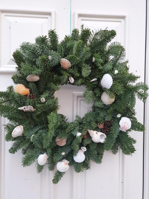 a christmas wreath with seashells on a door at Bay View House in Liscannor