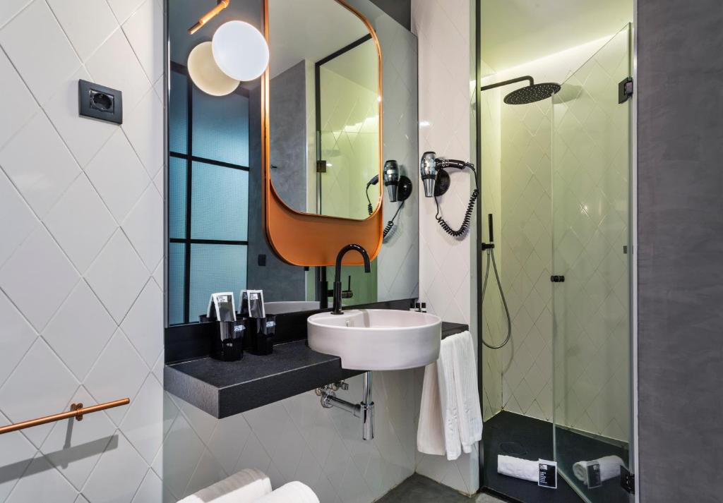a bathroom with a sink and a mirror at One Shot Tabakalera House in Donostia-San Sebastián